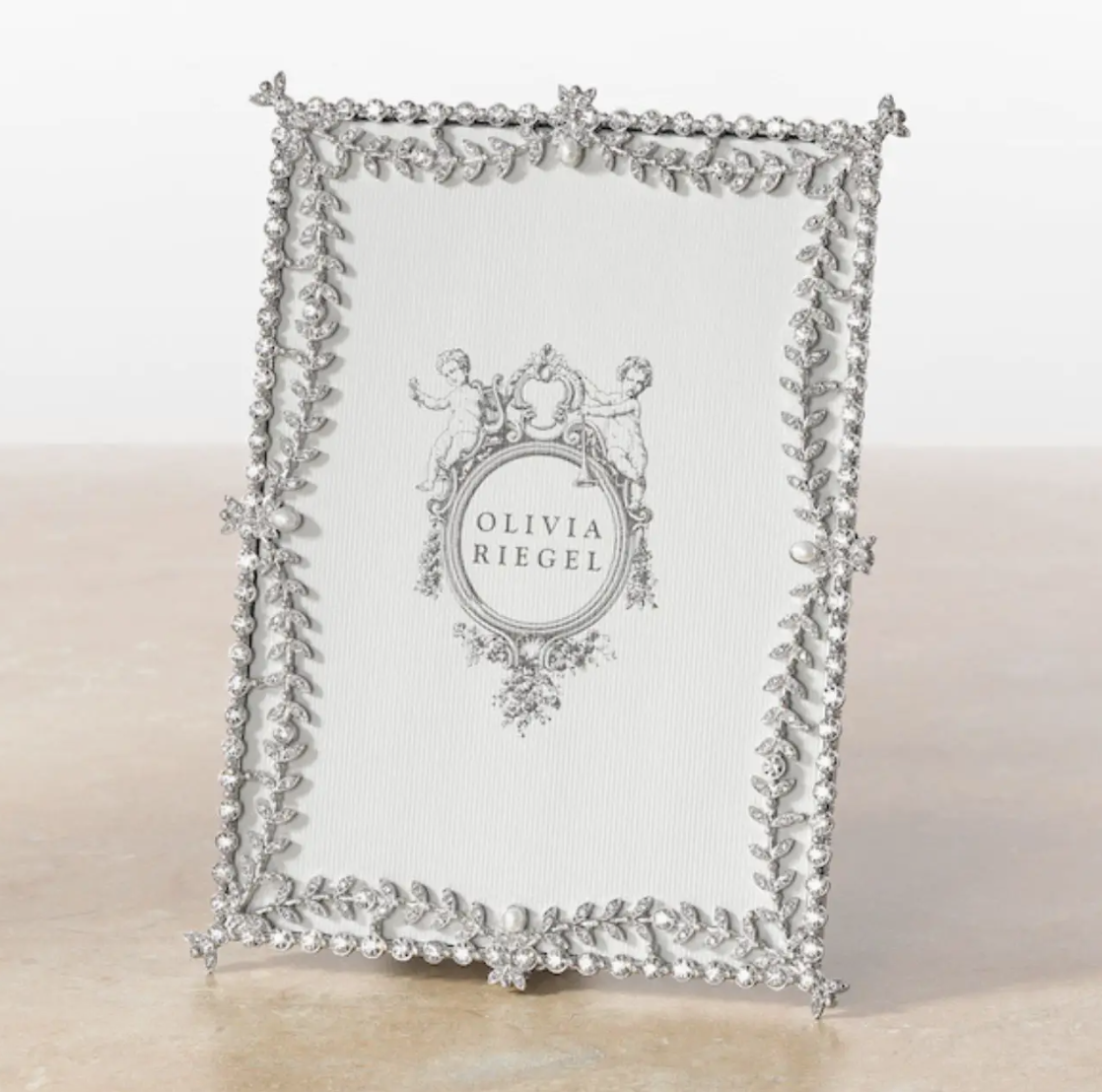Decorative silver frame with intricate design on a white background