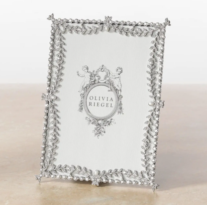 Decorative silver frame with intricate design on a white background