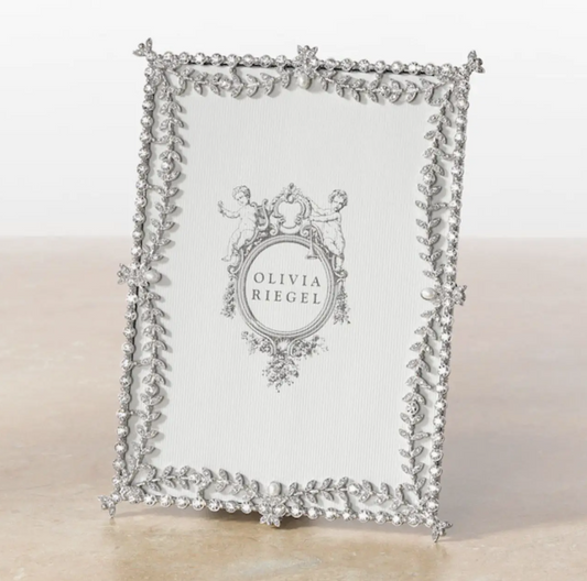 Decorative silver frame with intricate design on a white background