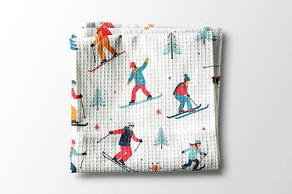 Folded blanket with skiing pattern on a light gray background