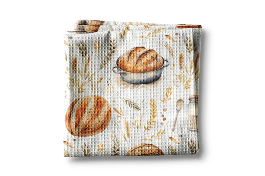 Waffle-textured towel with bread and wheat design on a white background