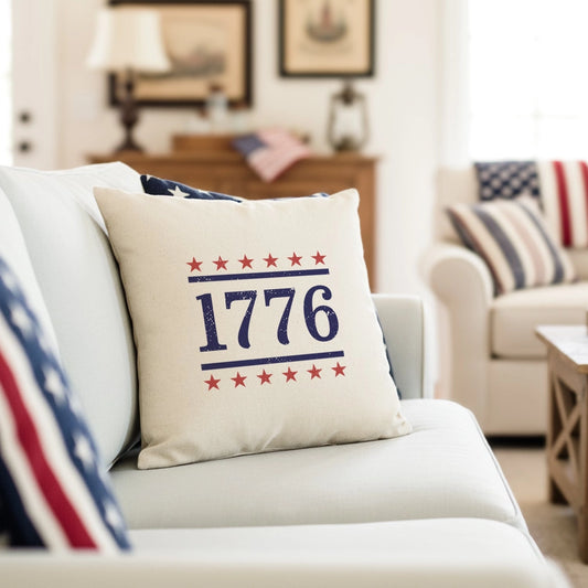 Decorative pillow with '1776' design on a couch in a living room setting.