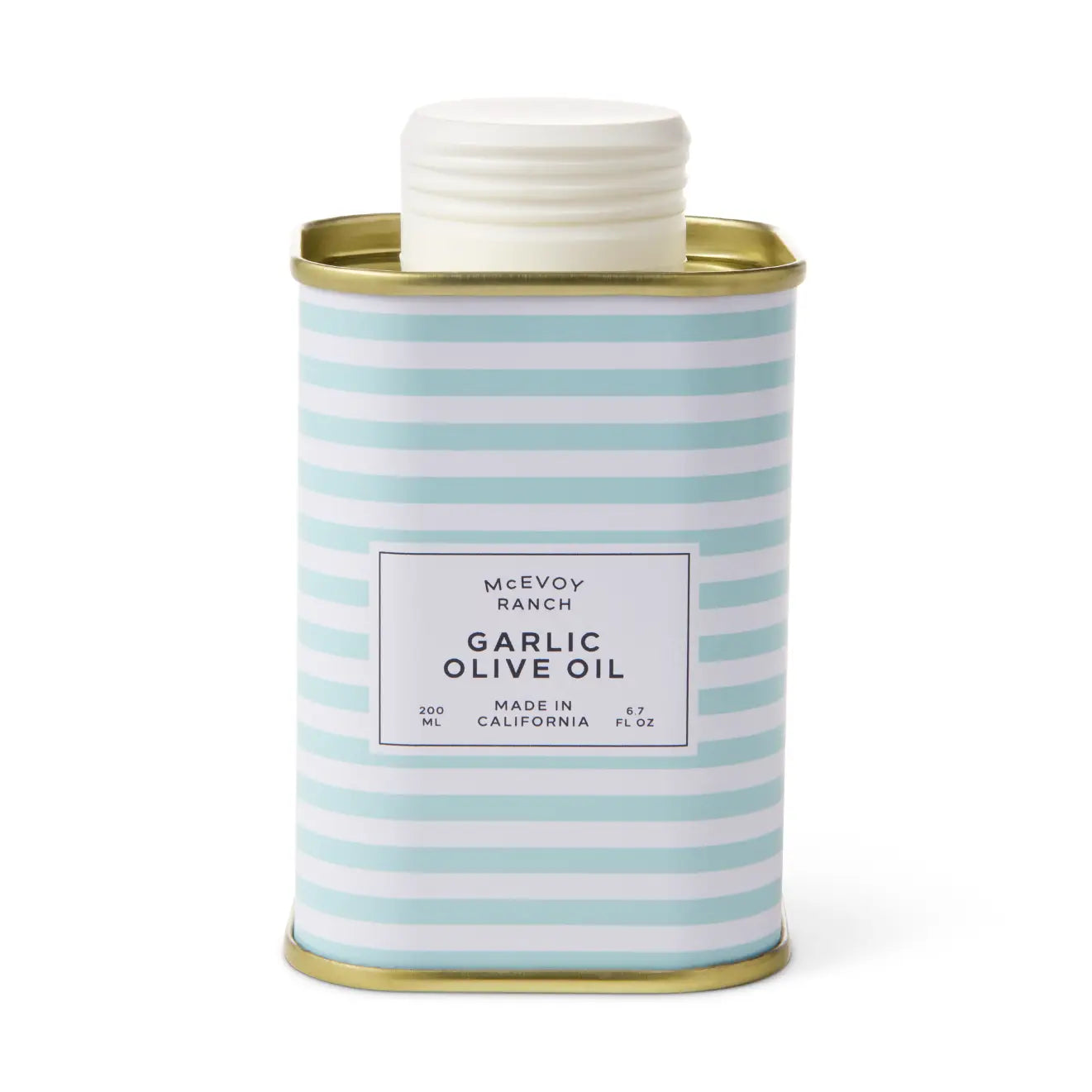 A McEvoy Ranch Garlic Olive Oil canister with a white screw cap, featuring a light blue and white striped body with a white label and gold metal trim, set against a plain white background.