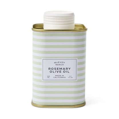 A McEvoy Ranch Rosemary Olive Oil container in a square metal tin with a white screw cap, featuring a white label with black text and a pattern of light green and white horizontal stripes, set against a plain white background.