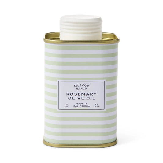 A McEvoy Ranch Rosemary Olive Oil container in a square metal tin with a white screw cap, featuring a white label with black text and a pattern of light green and white horizontal stripes, set against a plain white background.