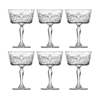 Set of six crystal glasses with intricate designs on a white background