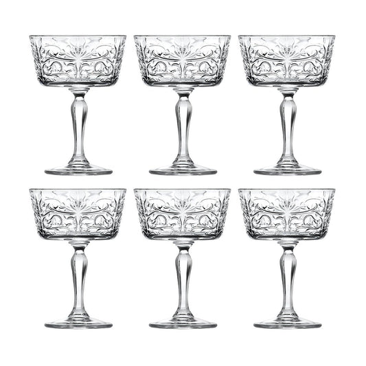 Set of six crystal glasses with intricate designs on a white background