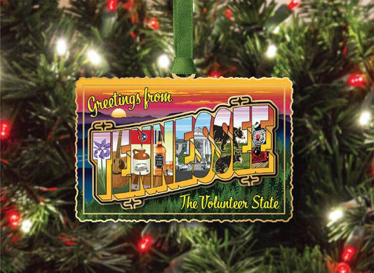 Decorative ornament with 'Greetings from Tennessee' design on a Christmas tree.