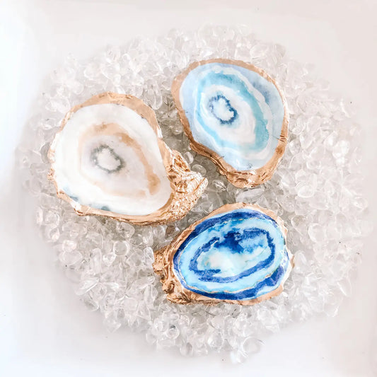 Three agate slices with blue and white patterns on a textured surface