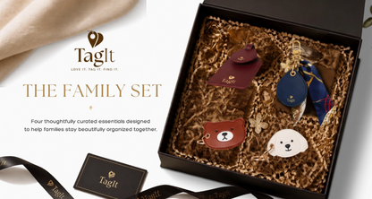 Family travel gift set featuring burgundy luggage tag, navy bag charm, bear and puppy accessories in gift box.