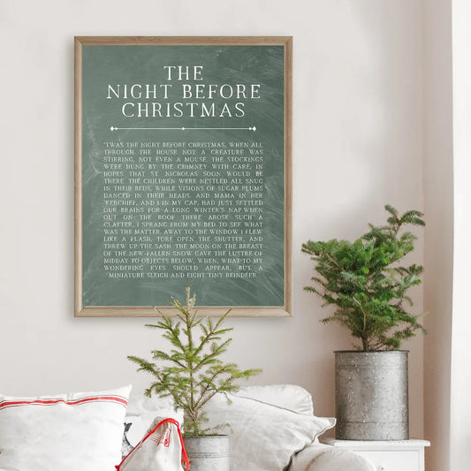 Framed print of 'The Night Before Christmas' on a wall with decorative plants and pillows.