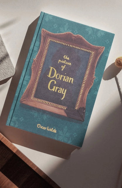 Book titled 'The Picture of Dorian Gray' by Oscar Wilde on a white surface.