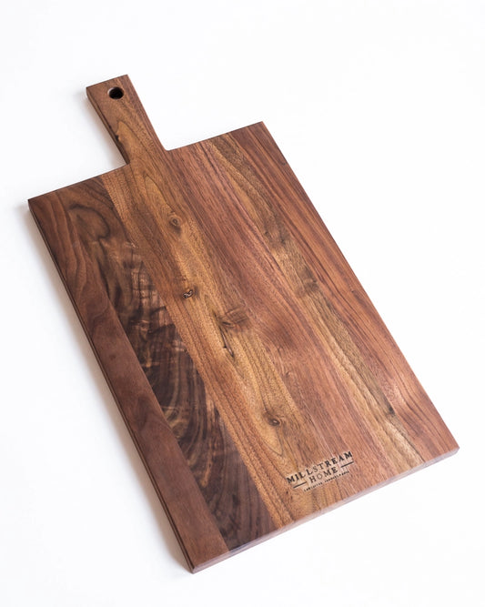 Wooden cutting board with a handle on a white background