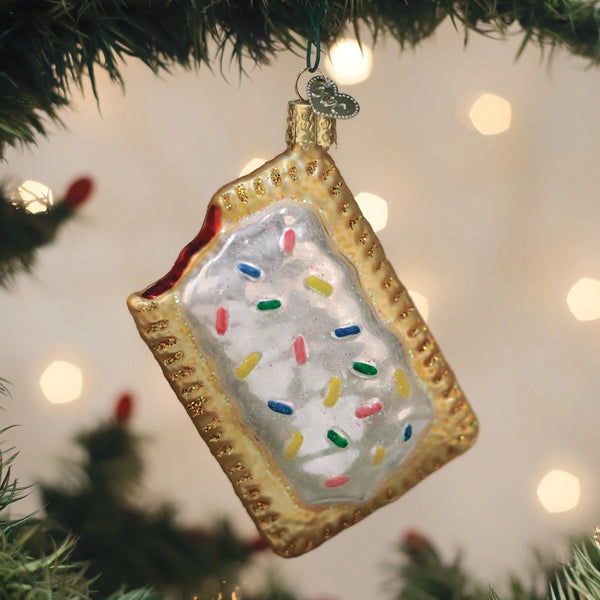 Decorative Christmas ornament shaped like a square cookie with sprinkles on a Christmas tree.