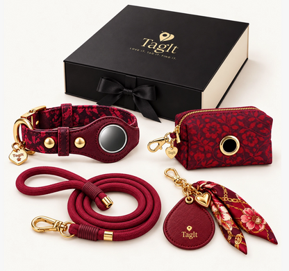 Burgundy Together Everywhere Gift Set with floral AirTag-compatible dog collar, matching rope leash, floral poop-bag holder, heart keychain with scarf, and black gift box.