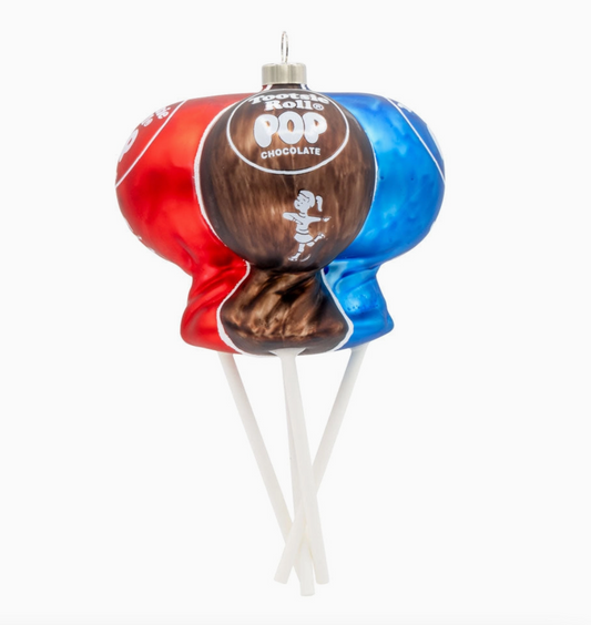 A novelty Christmas ornament shaped like a lollipop, featuring a red and blue candy-coated shell with a brown chocolate center and white hanging sticks, on a plain white background.