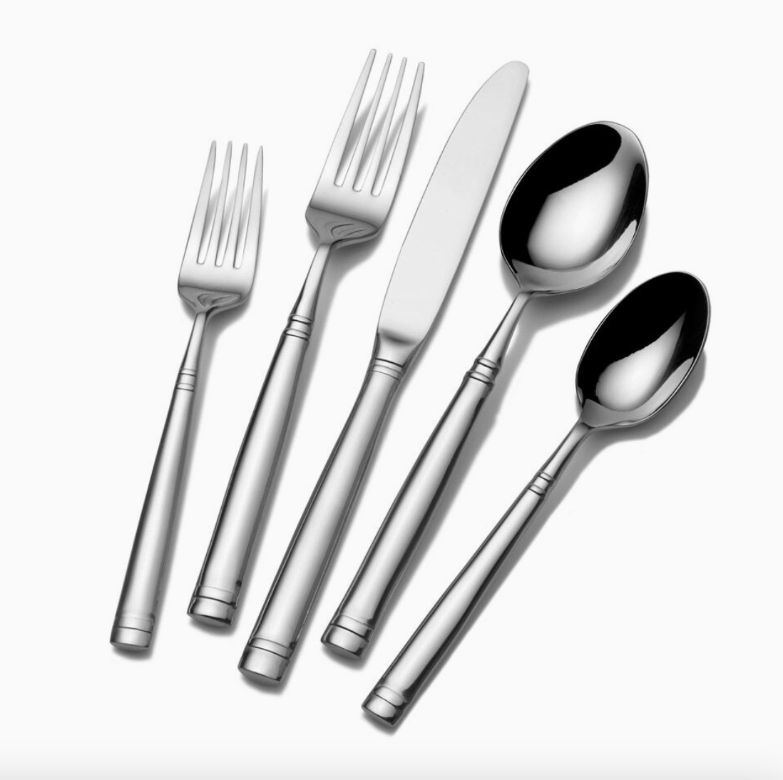 Towle Living Stephanie 20-piece stainless steel flatware set featuring sleek tapered handles, subtle line detailing and polished mirror finish.