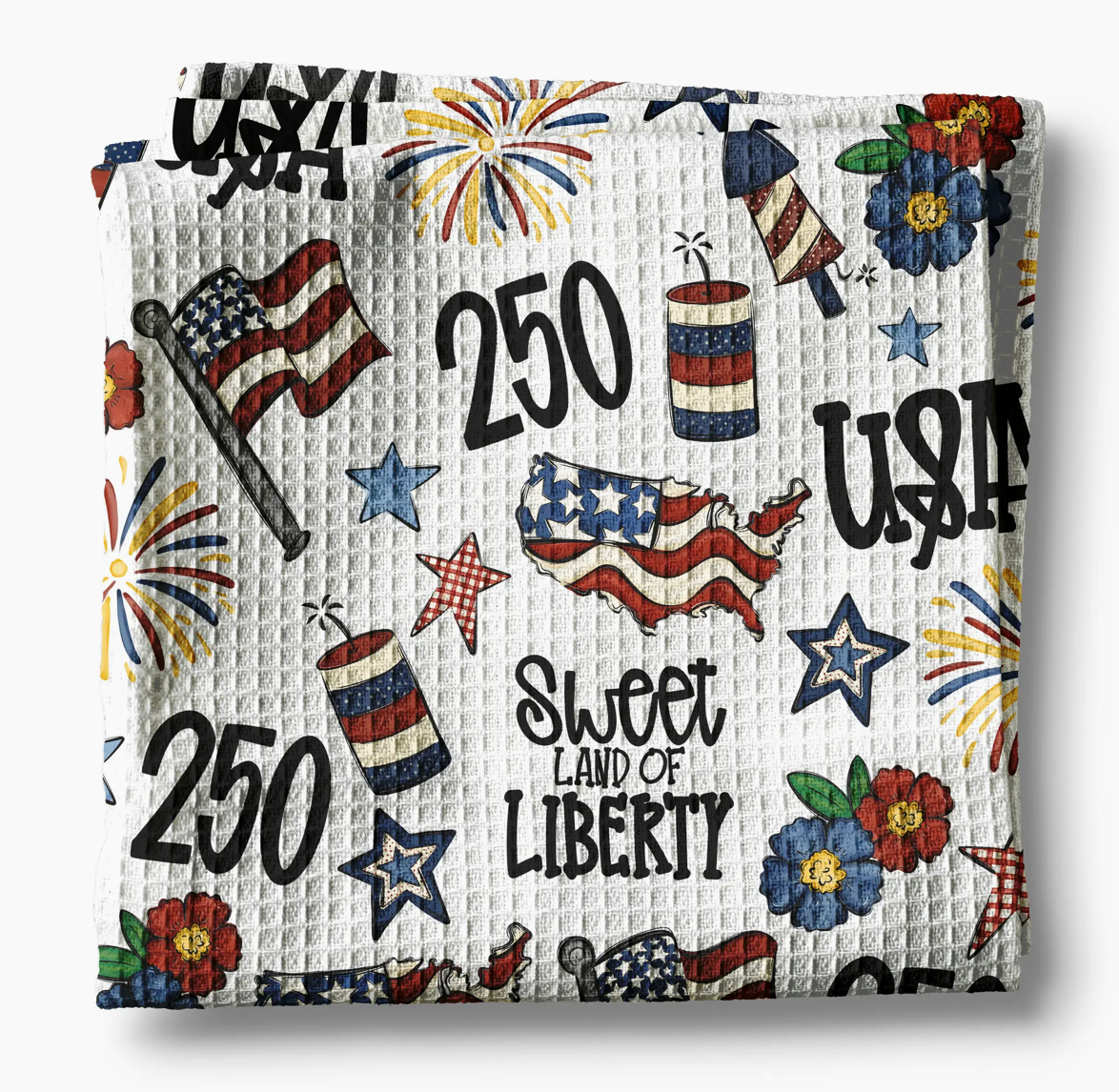 Decorative blanket with American-themed patterns including stars, stripes, and 'Sweet Land of Liberty' text.