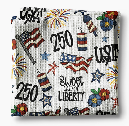 Decorative blanket with American-themed patterns including stars, stripes, and 'Sweet Land of Liberty' text.