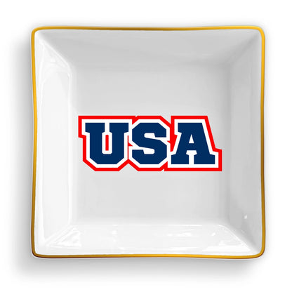 White square dish with 'USA' in blue and red text on a white background