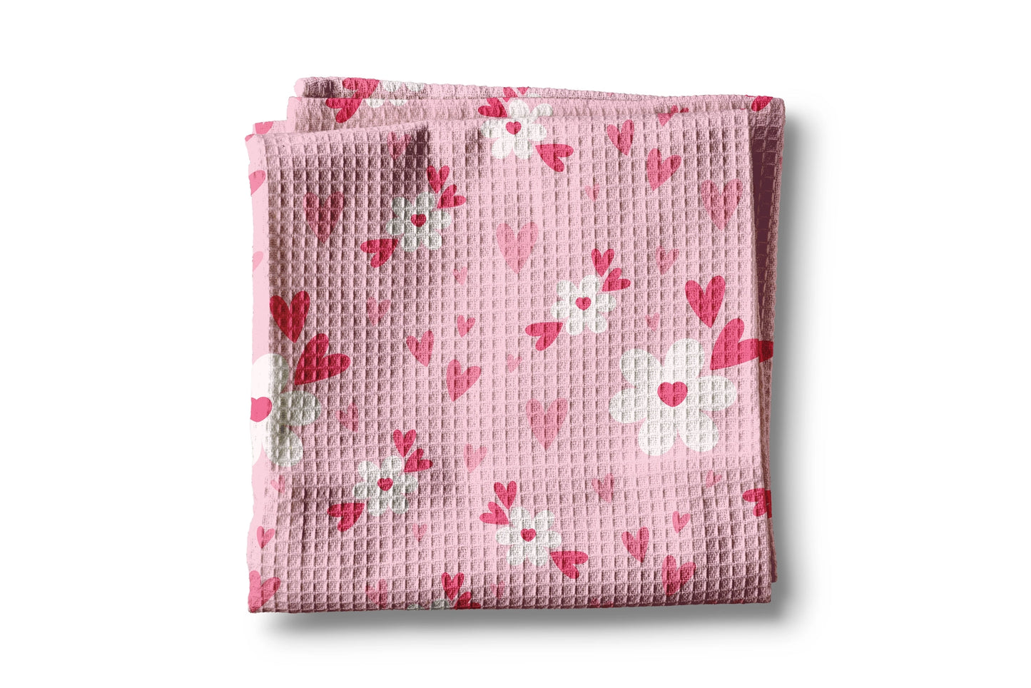 Folded pink fabric with heart pattern on a white background