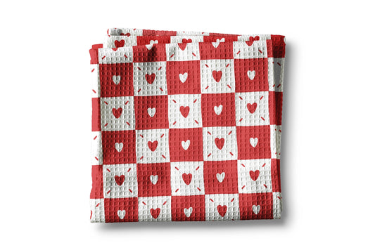 Red and white checkered blanket with heart patterns on a white background