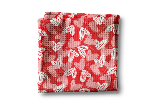 Red fabric with white heart pattern on a white background
