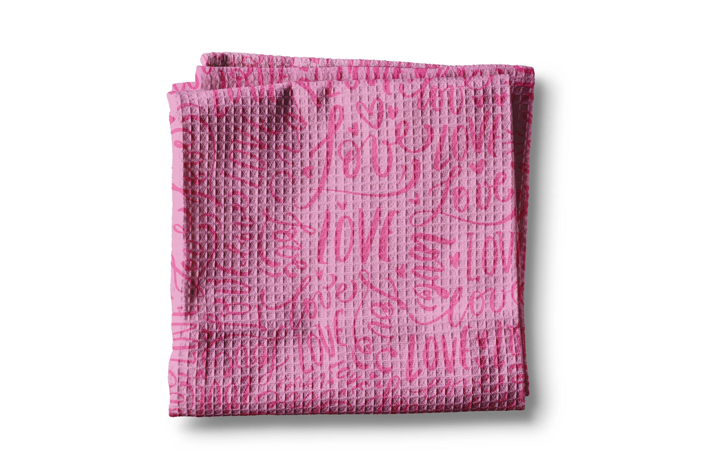 Pink textured towel with text on a white background