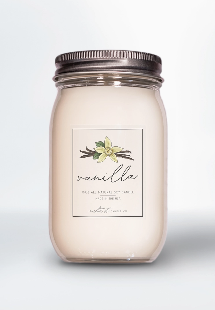 Vanilla Classic soy candle in clear glass Ball jar with silver lid and vanilla flower label.