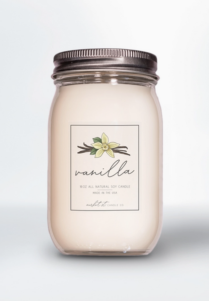 Vanilla Classic soy candle in clear glass Ball jar with silver lid and vanilla flower label.