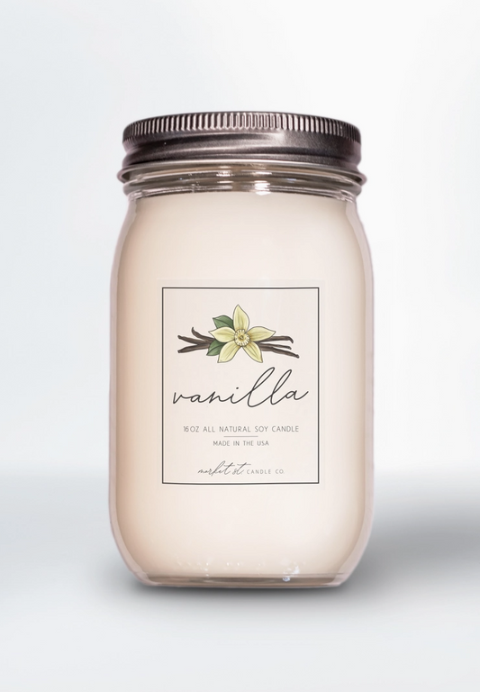 Vanilla Classic soy candle in clear glass Ball jar with silver lid and vanilla flower label.