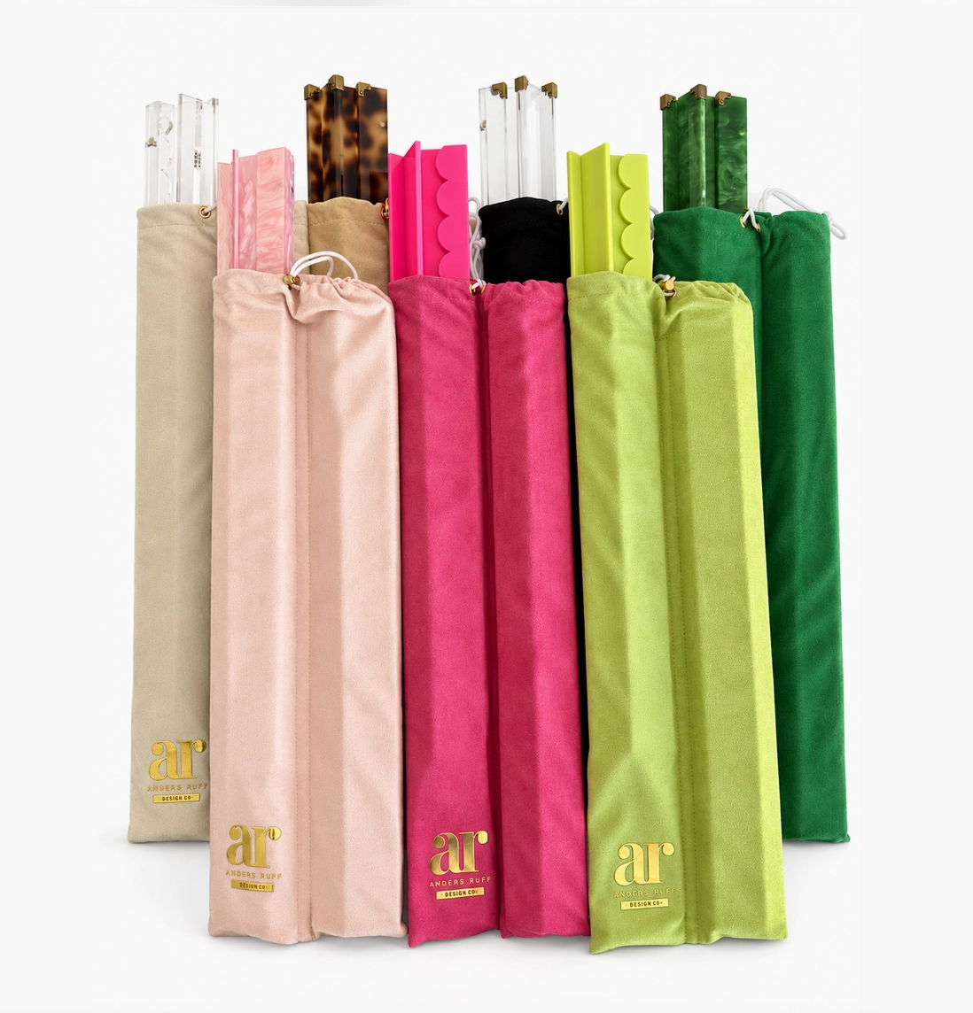 Colorful Mahjong rack sets displayed in individual velvet storage covers with pink, green, clear, and tortoiseshell acrylic finishes.