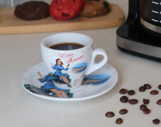 Espresso cup with saucer on a kitchen counter with coffee beans and a coffee machine.