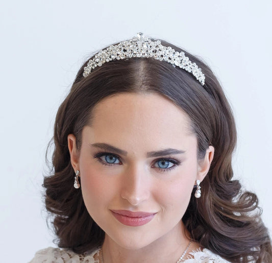 Woman wearing a tiara with a plain background