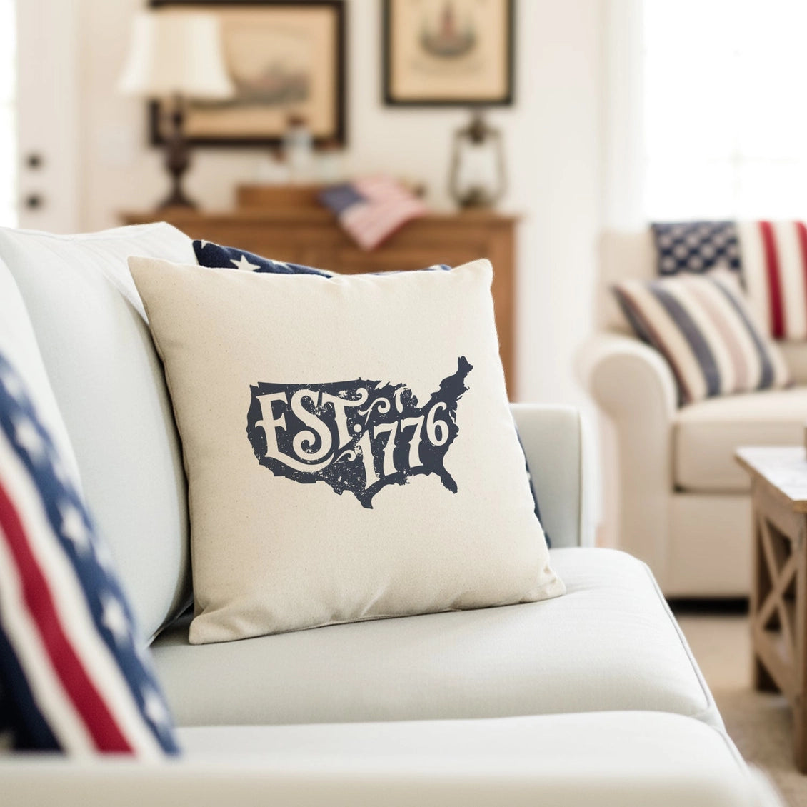 Decorative pillow with 'EST. 1776' design on a couch in a living room setting.