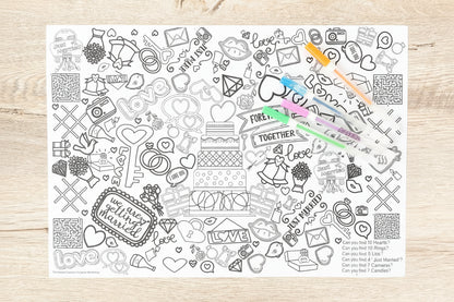 Coloring page with various designs and text on a wooden surface with markers.