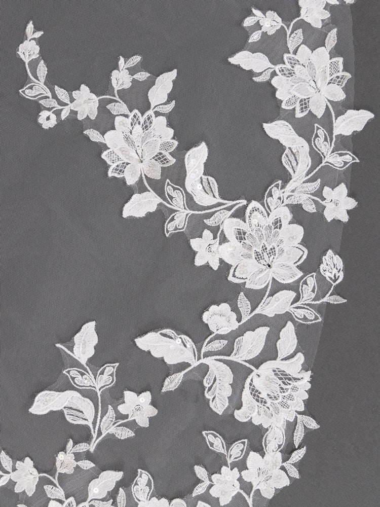White floral lace fabric on a dark background