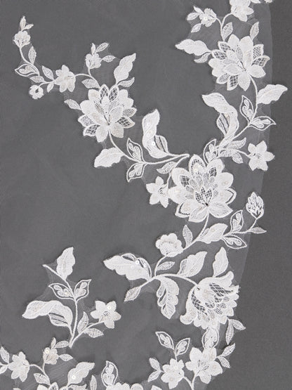 White floral lace fabric on a dark background