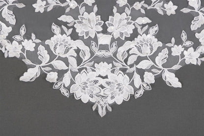 White floral lace on a dark gray background