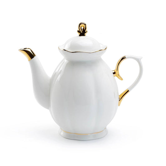 White teapot with gold accents on a white background