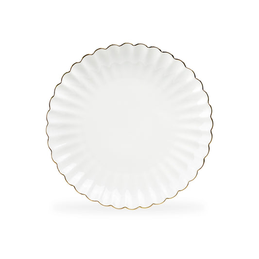 White plate with scalloped edge and gold trim on a white background