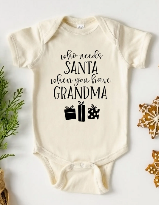Baby onesie with text 'who needs Santa when you have Grandma' on a white background