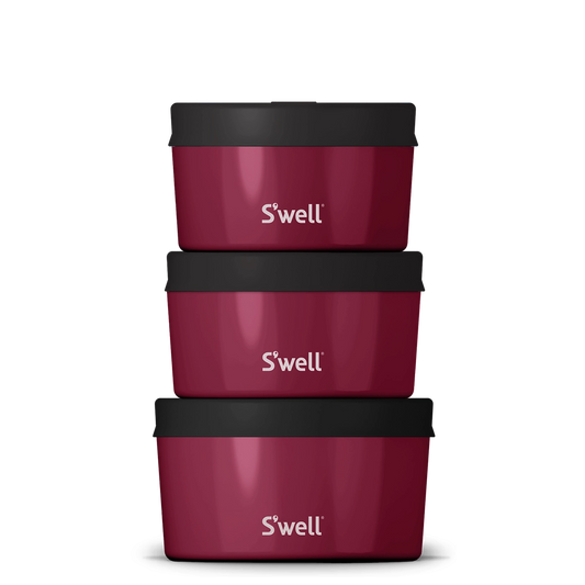 Three maroon S'well containers with black lids on a white background