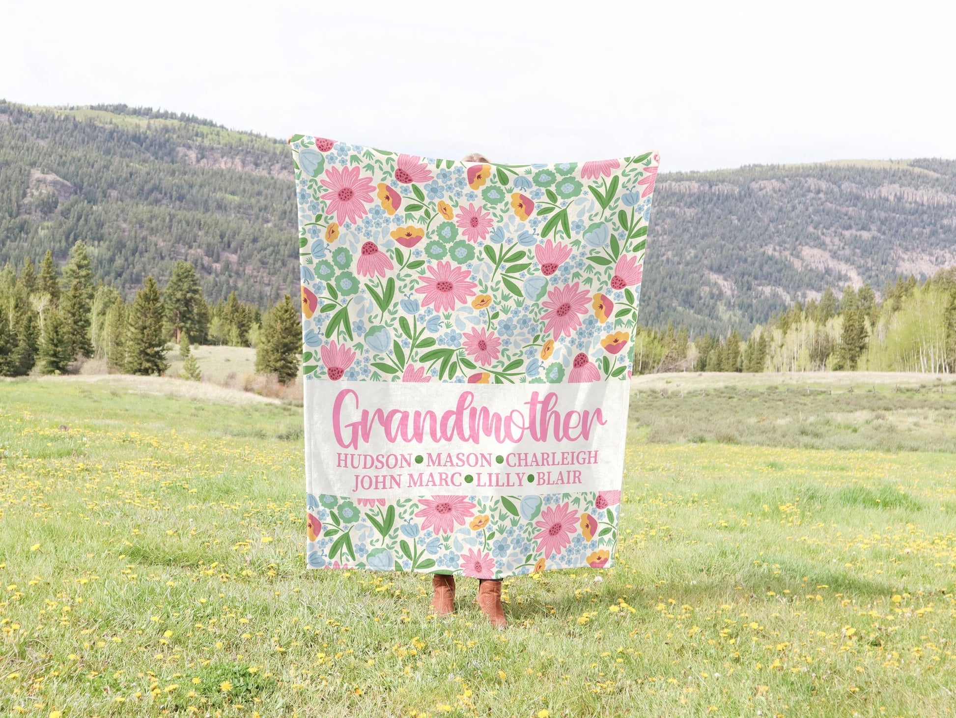 Floral blanket with 'Grandmother' and children's names on a grassy field background