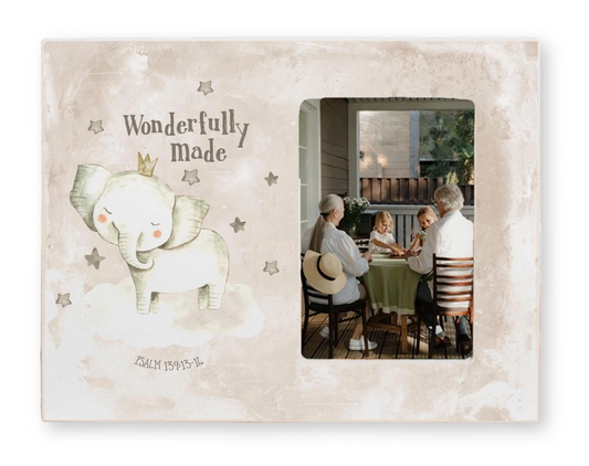 Decorative frame with an elephant illustration and text, featuring a family at a table.