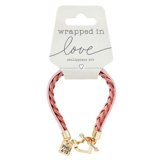 Bracelet with gold clasp and pink braided cord on a 'wrapped in love' card.