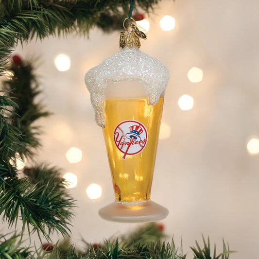 Christmas ornament shaped like a glass of beer with a Yankees logo, hanging on a tree.