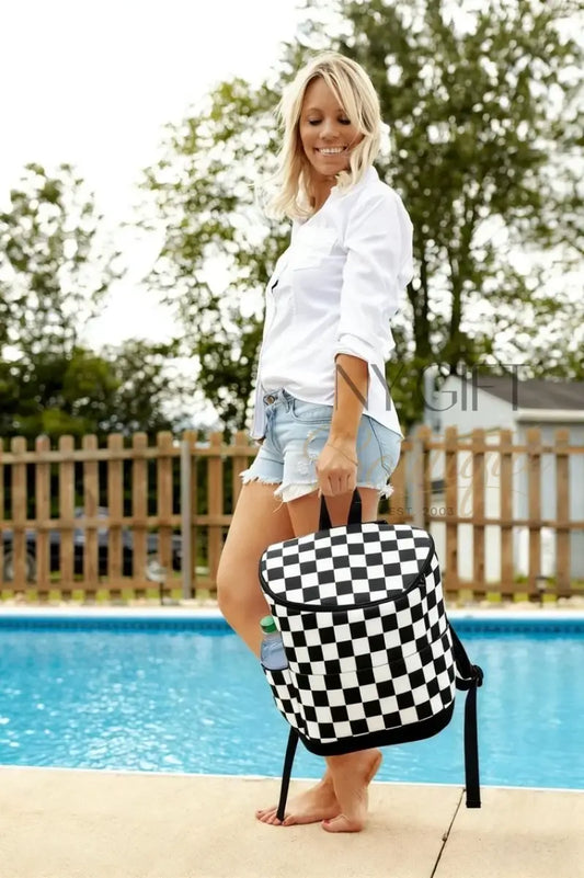 Woman holding a black and white checkered bag by a pool