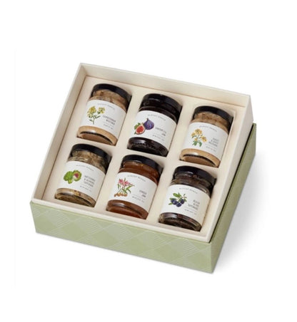 Set of six jars in a decorative box on a white background