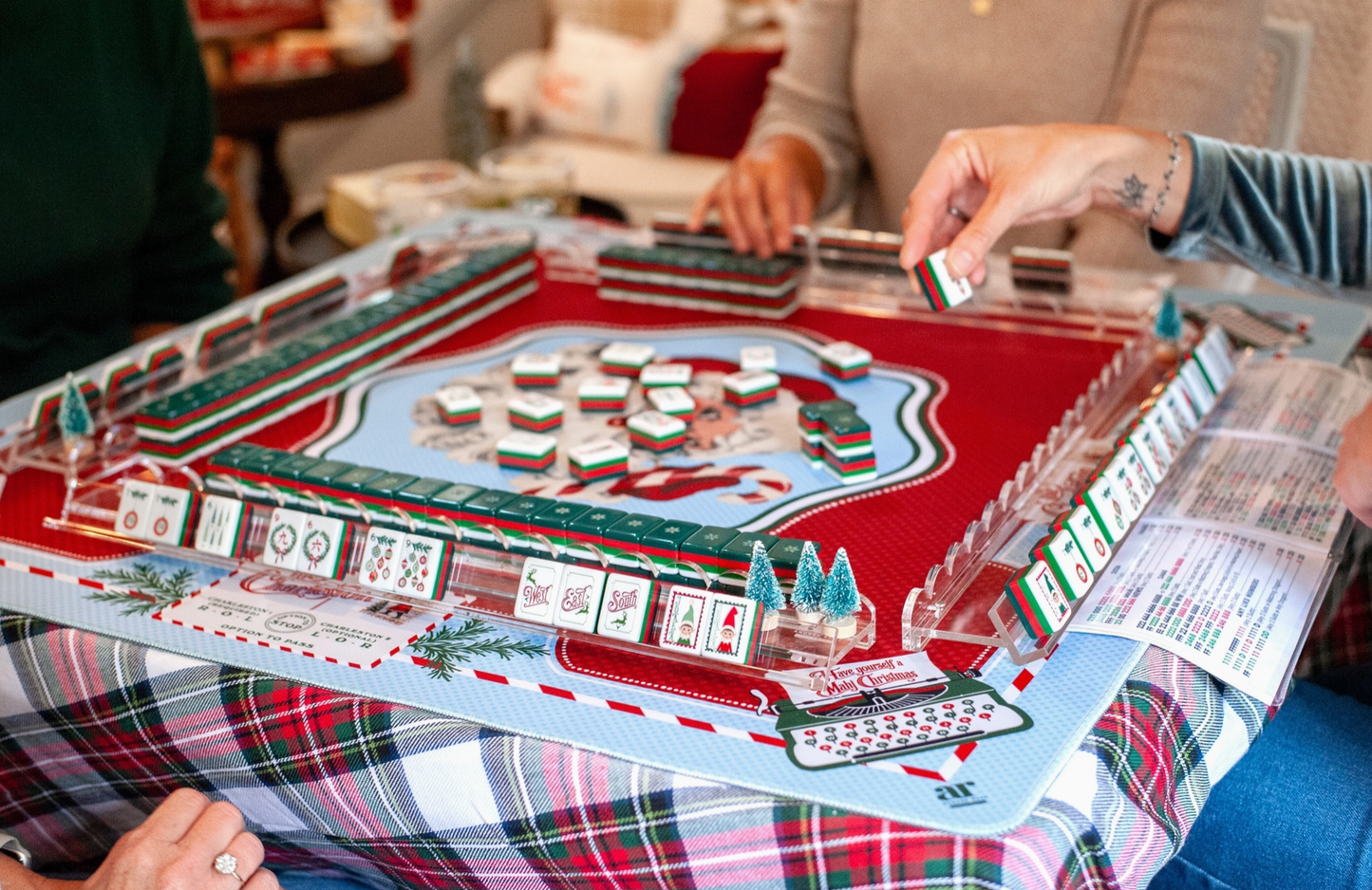 Christmas Mahjong game night featuring Dear Santa holiday tiles with a coordinating festive Mahjong mat and acrylic tile racks.